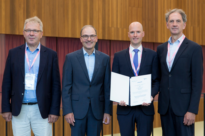 v.l.: Prof. Dr. Reinhold Förster, Präsident der DGfI, Dr. Andreas Kreiss (Novartis-Stiftung für Therapeutische Forschung), Dr. Dr. Lukas Bunse, Prof. Dr. Jürgen Ruland (Laudator bei der Preisverleihung) ®PhilippeGroslier 